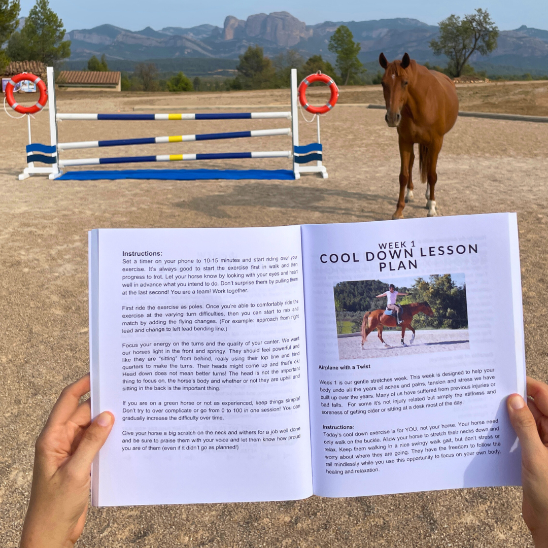 A person holds an open horseback riding lesson book titled "Week 1 Cool Down Lesson Plan" in front of a training setup with jump poles and a horse